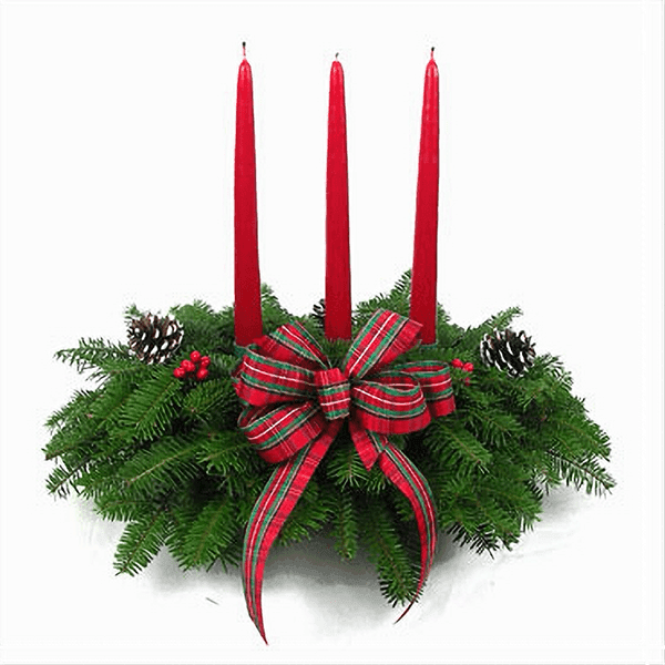 Ribbon Candy Centerpiece with Balsam greenery, candy-inspired ornaments, and a red candle.